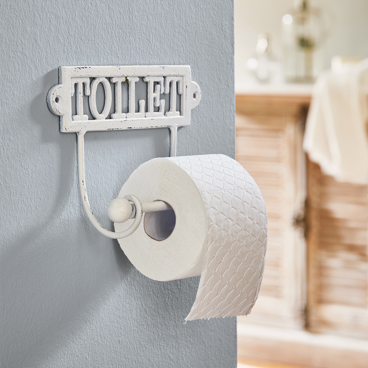 Uchwyt na papier toaletowy Miramas Metalowy biały uchwyt na papier toaletowy z napisem TOILET do łazienki w stylu vintage