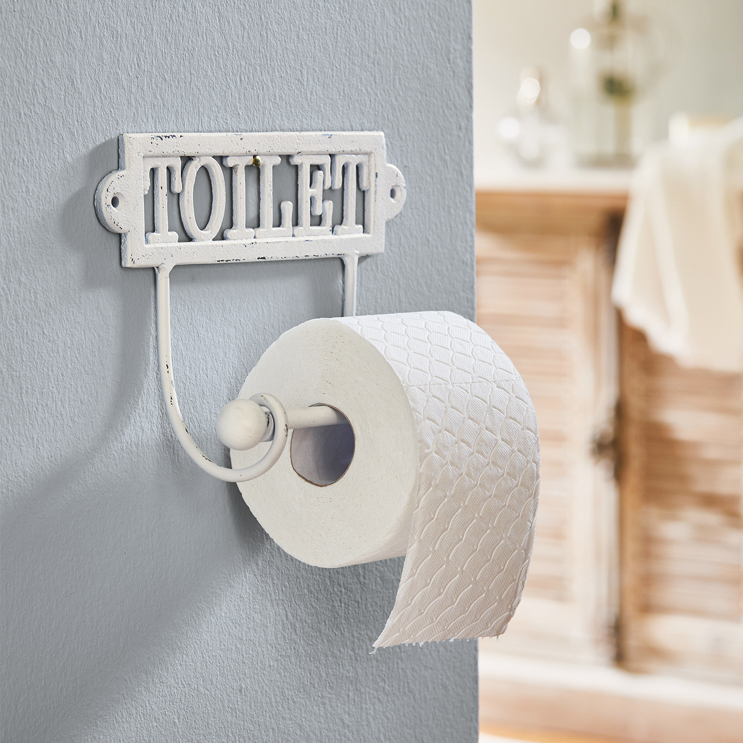 Uchwyt na papier toaletowy Miramas Metalowy biały uchwyt na papier toaletowy z napisem TOILET do łazienki w stylu vintage
